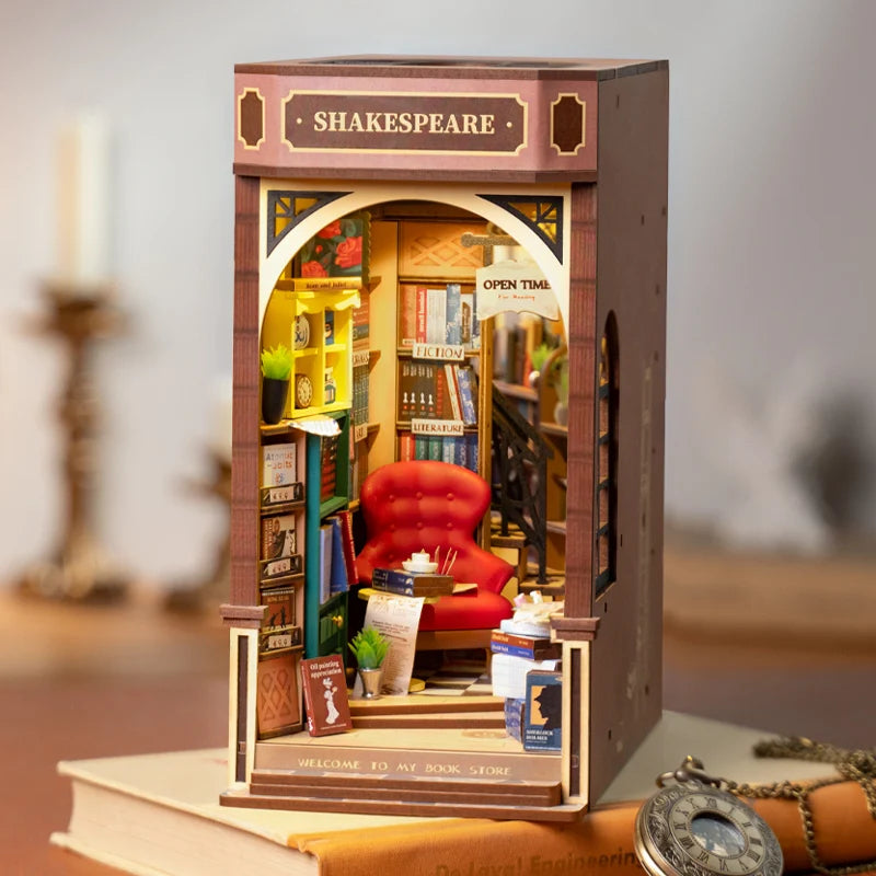 Wooden model of a bookshelf with a red chair, books, and decorative items, labeled 'Shakespeare'.