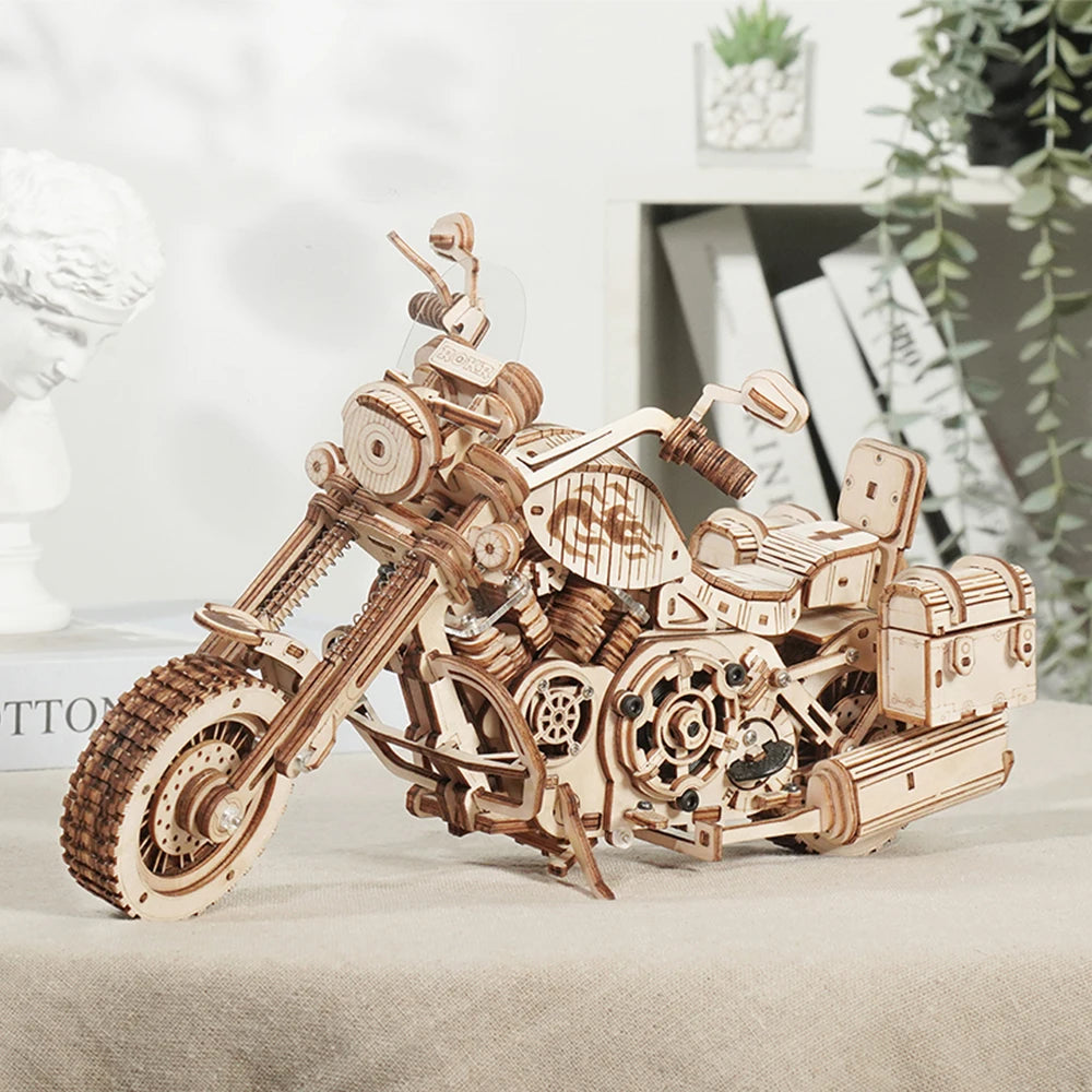 Wooden motorcycle model on a light surface with a blurred indoor background