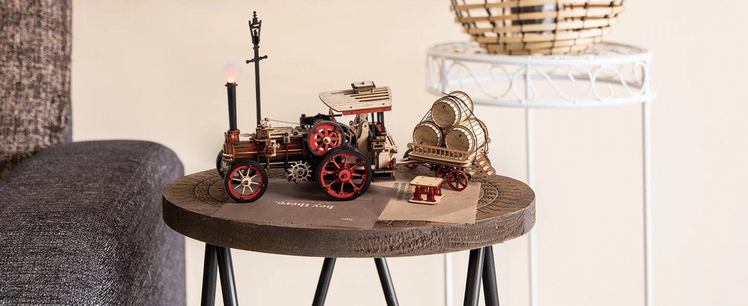 Small round wooden table with decorative steam train model on a neutral background