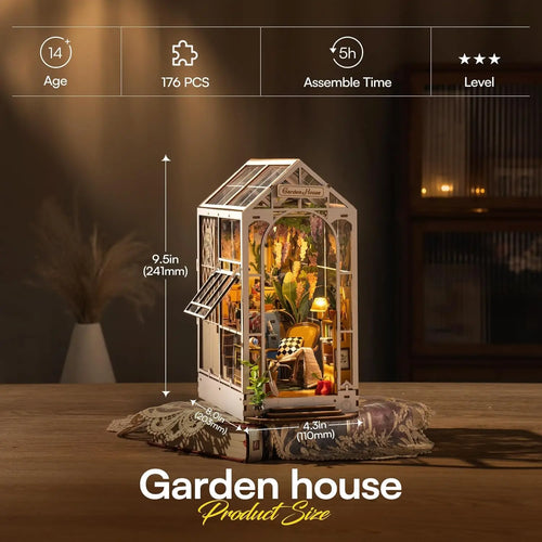 Model of a garden house with assembly details on a wooden table