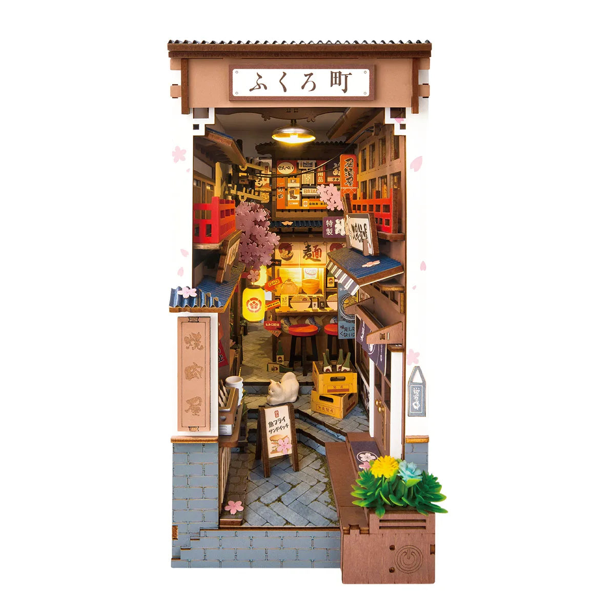 Miniature model of a Japanese street scene with shops and pedestrians.