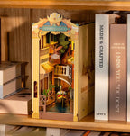 Model of a floating city between books with 'Romantic Venice' branding on a wooden shelf.