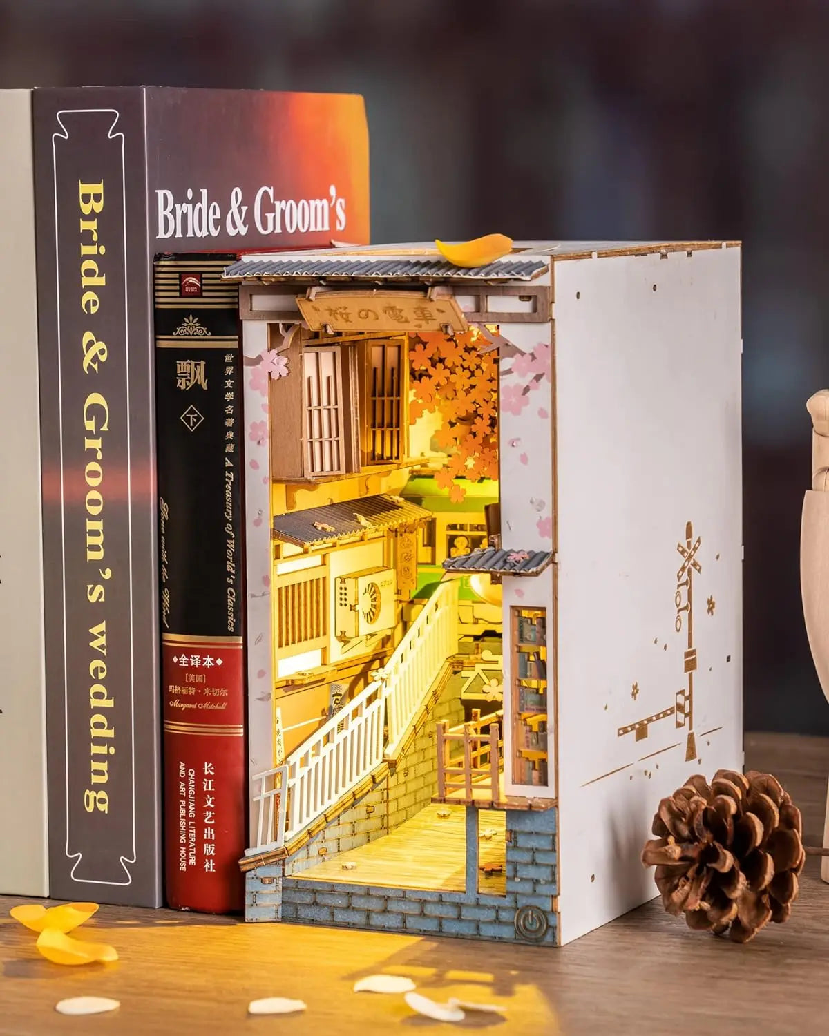 Light-up model of a wedding scene inside a book-shaped box with 'Bride & Groom's wedding' text.
