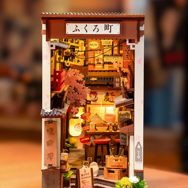 Miniature model of a Japanese store with detailed interior and signage.